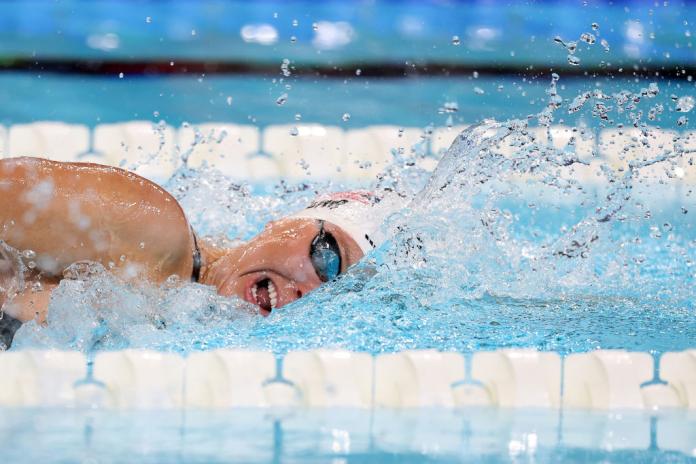 A female Para swimmer is competing in the freestyle event